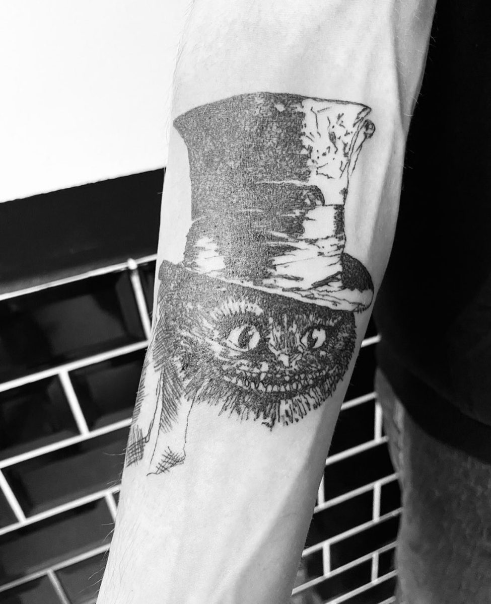Dotwork hoge hoed met kat op de onderarm.